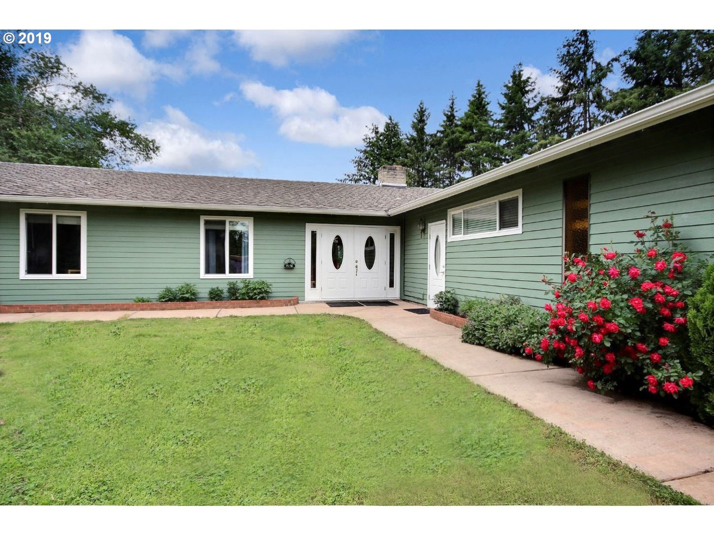 22505 Northwest Gillihan Road Portland, OR 97231 - Photo 5 of 32 a front view of a house with a garden