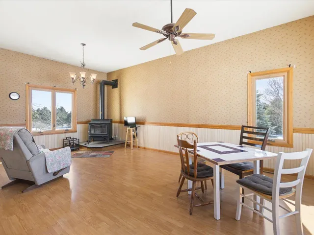 a view of a hallway with wooden floor and door