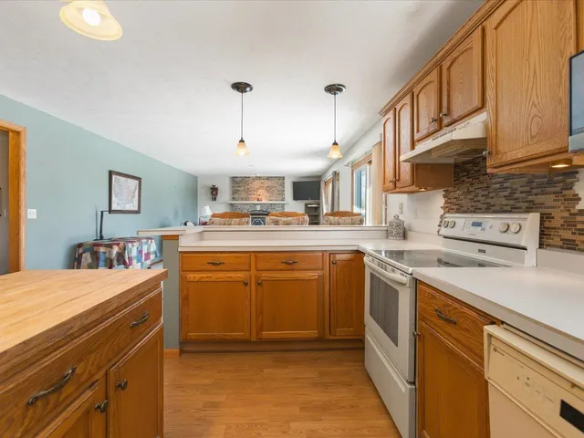 a kitchen with stainless steel appliances granite countertop a refrigerator and a sink