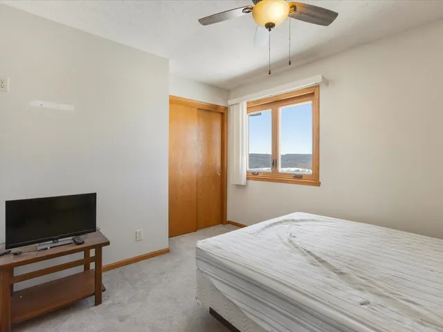 a view of empty room with wooden floor and windows