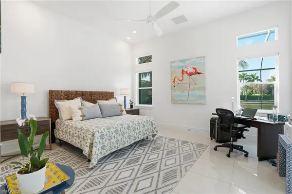 a bedroom with a bed a couch and a window