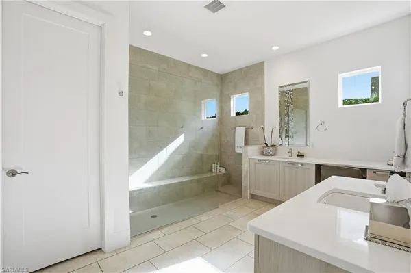 a bathroom with a tub sink and mirror