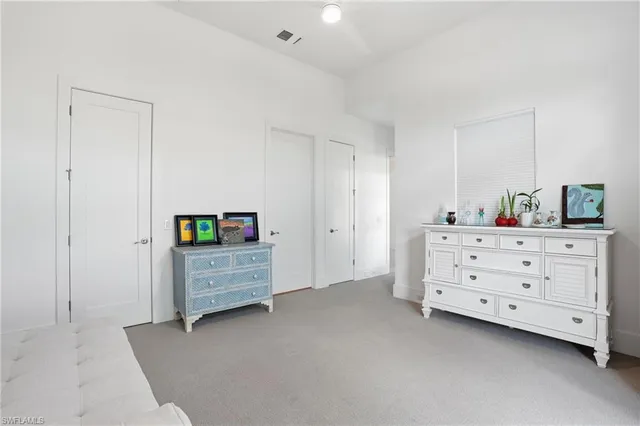 a view of a bedroom with furniture and cabinet