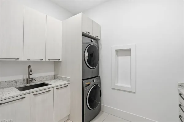 a utility room with sink dryer and washer