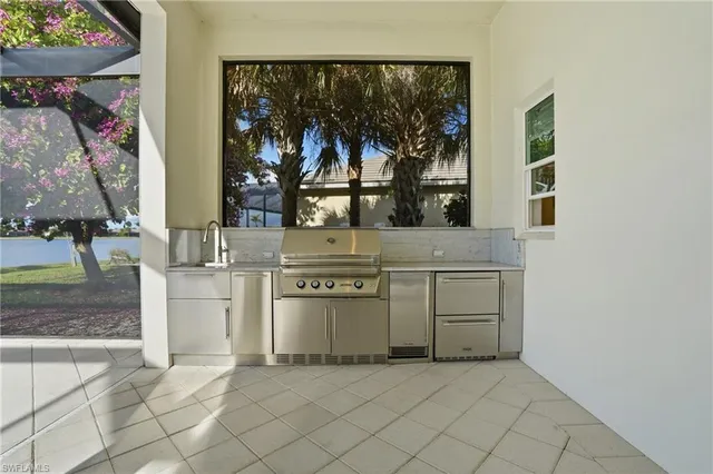 an open kitchen with a sink and a stove top oven