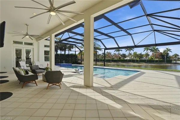 a view of a patio with a table and chairs under an umbrella
