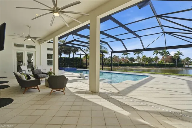 a view of a patio with a table and chairs under an umbrella