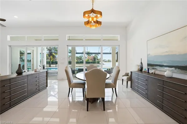 a dining room with furniture a window and a chandelier