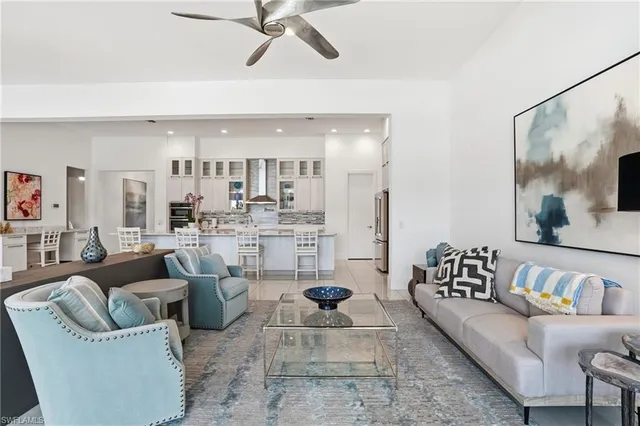 a living room with furniture and a view of kitchen