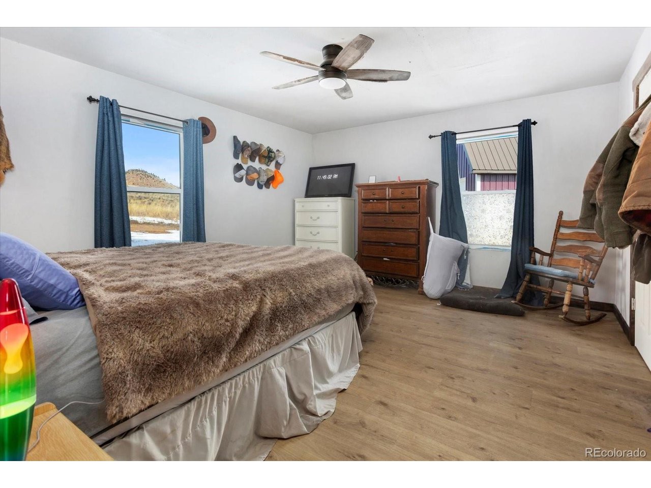 51624 Co Road Villa Grove, CO 81155 - Photo 14 of 50 a bedroom with a bed a dresser and a chandelier