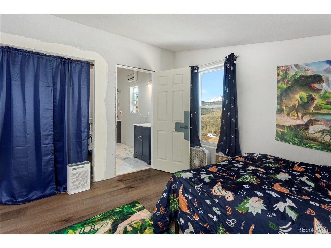 51624 Co Road Villa Grove, CO 81155 - Photo 26 of 50 a bedroom with a bed and a painting on the wall