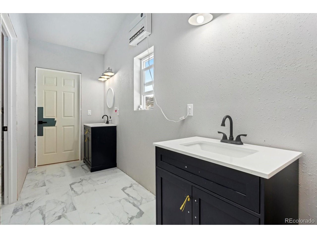 51624 Co Road Villa Grove, CO 81155 - Photo 27 of 50 a bathroom with a sink a mirror and a shower