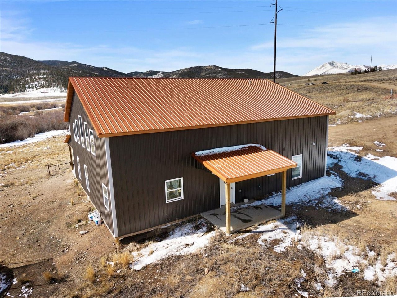 51624 Co Road Villa Grove, CO 81155 - Photo 31 of 50 a backyard of a house with table and chairs under an umbrella