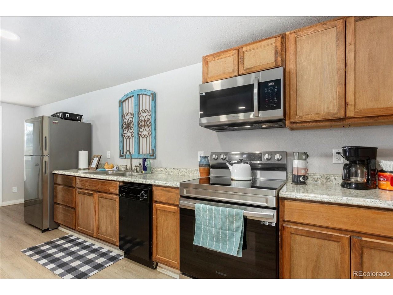 51624 Co Road Villa Grove, CO 81155 - Photo 41 of 50 a kitchen with stainless steel appliances granite countertop a sink stove and microwave