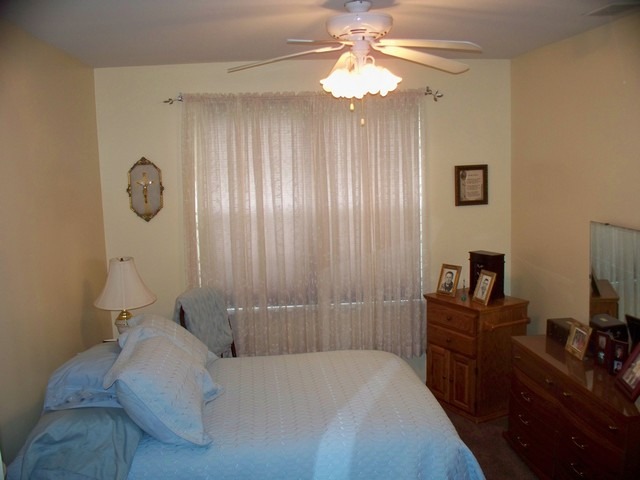 3016 Falling Waters Lane, Unit 3016 Lindenhurst, IL 60046 - Photo 11 of 21 a bedroom with a bed and a chandelier