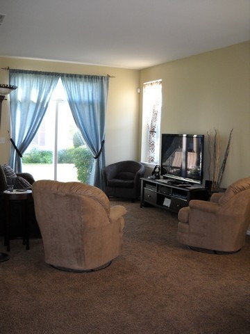 3016 Falling Waters Lane, Unit 3016 Lindenhurst, IL 60046 - Photo 8 of 21 a living room with furniture and a flat screen tv