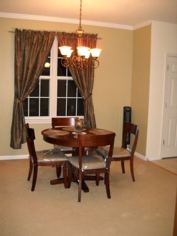 3016 Falling Waters Lane, Unit 3016 Lindenhurst, IL 60046 - Photo 10 of 21 a room with a table chair and a window