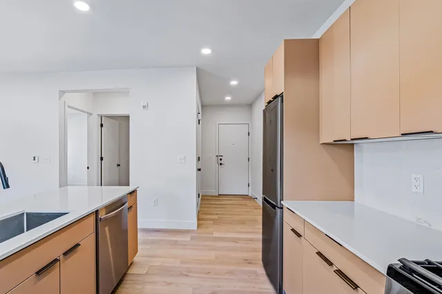 a view of a kitchen counter space with wooden floor