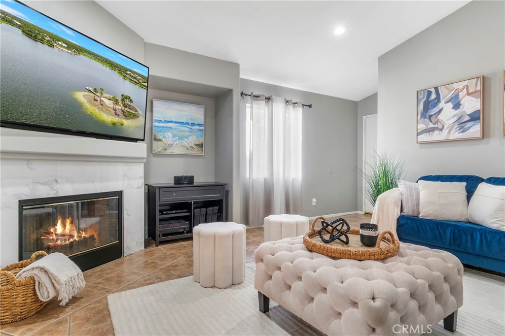 16366 West Sun Canyon Street Riverside, CA 92503 - Photo 4 of 21 a living room with furniture a fireplace and a flat screen tv