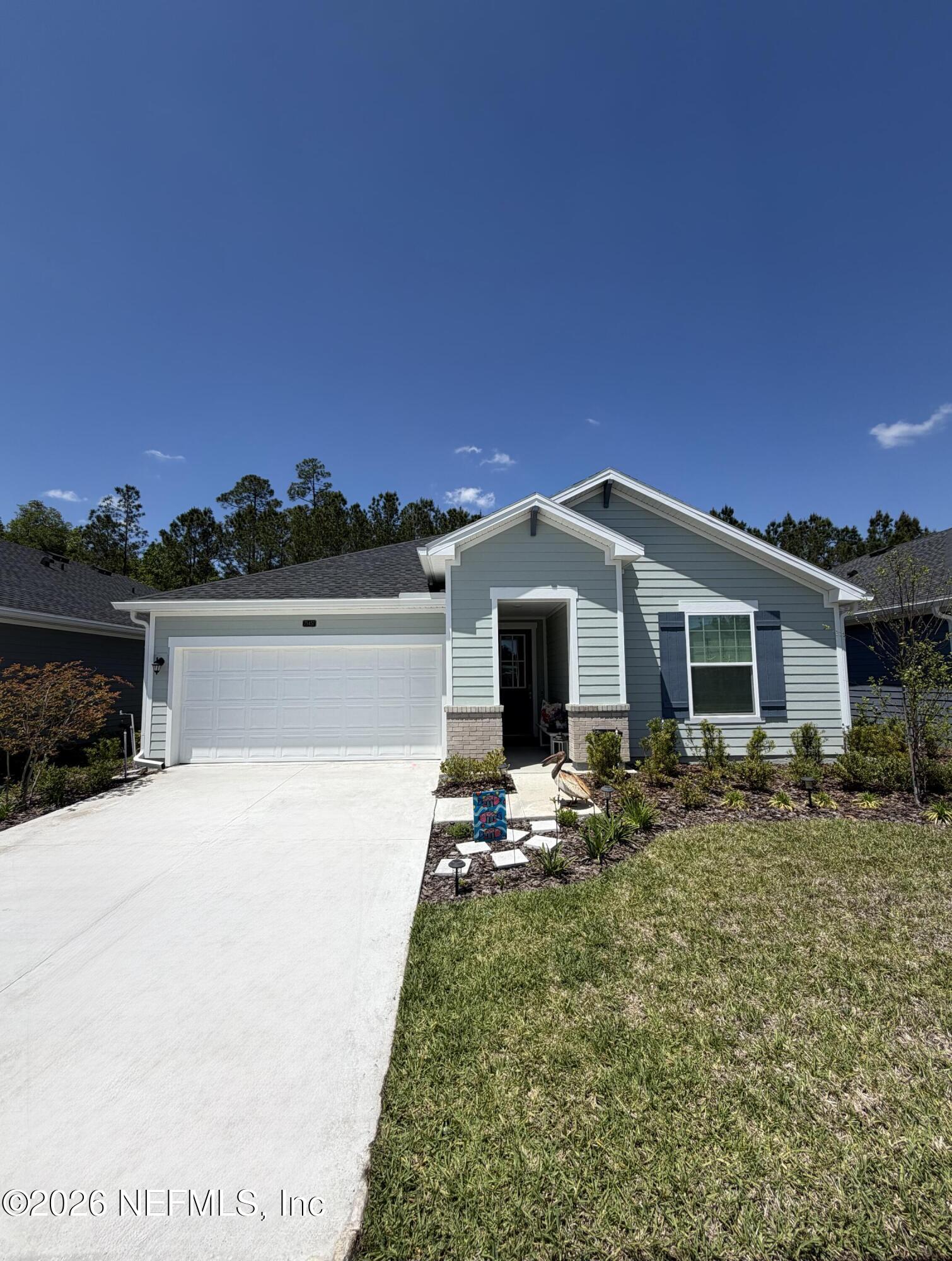 a front view of house with yard seating and green space