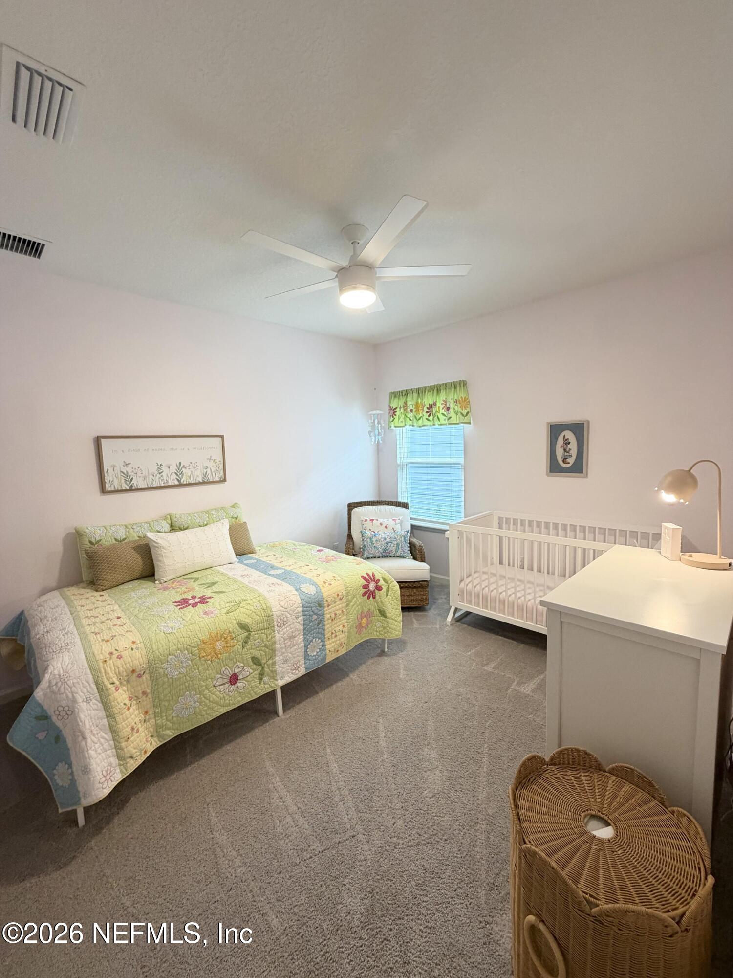 75457 Banyan Way Yulee, FL 32097 - Photo 11 of 36 a bedroom with bed and a couch