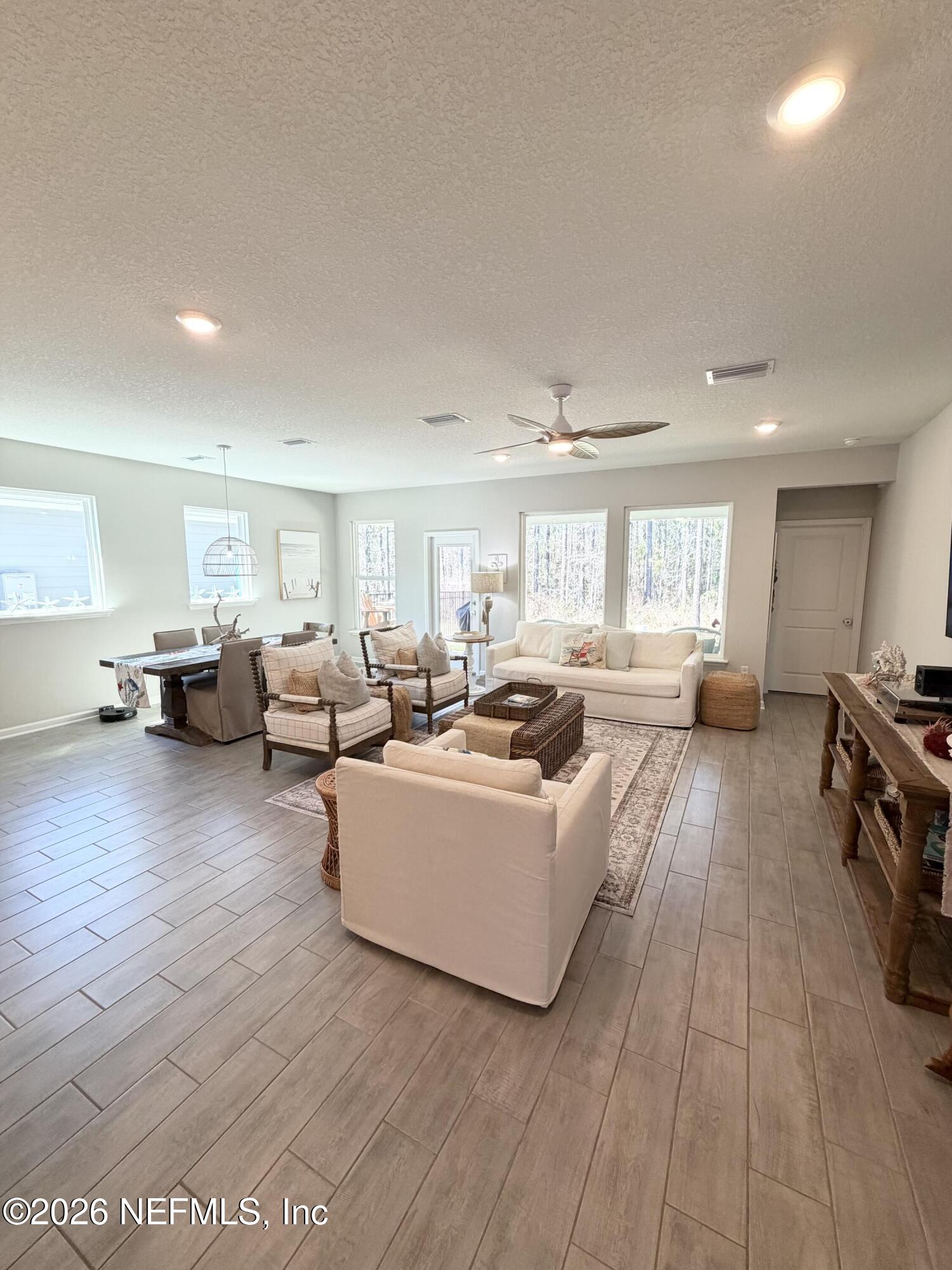 75457 Banyan Way Yulee, FL 32097 - Photo 14 of 36 a living room with furniture and a wooden floor