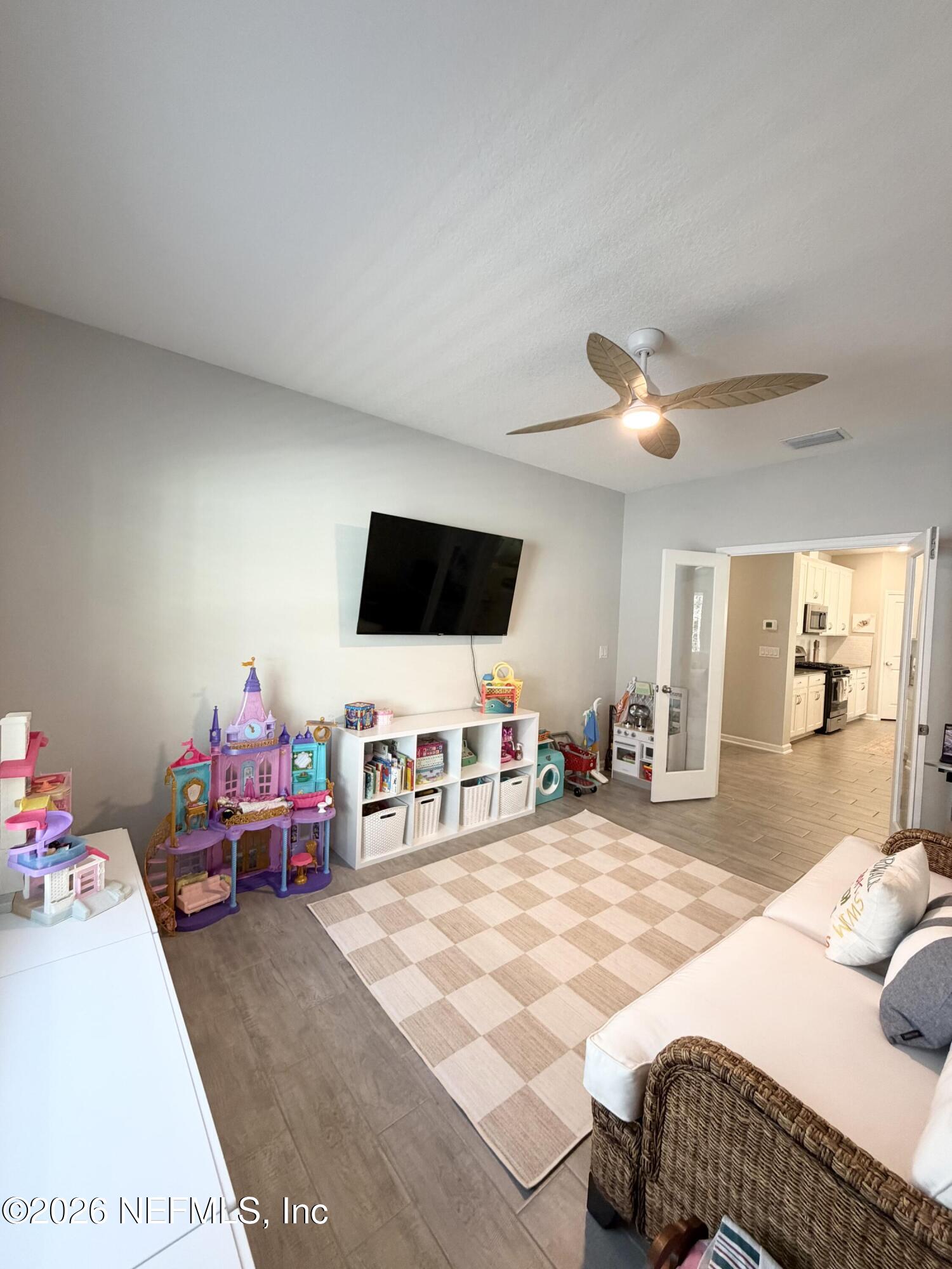 75457 Banyan Way Yulee, FL 32097 - Photo 17 of 36 a bedroom with furniture and a flat screen tv