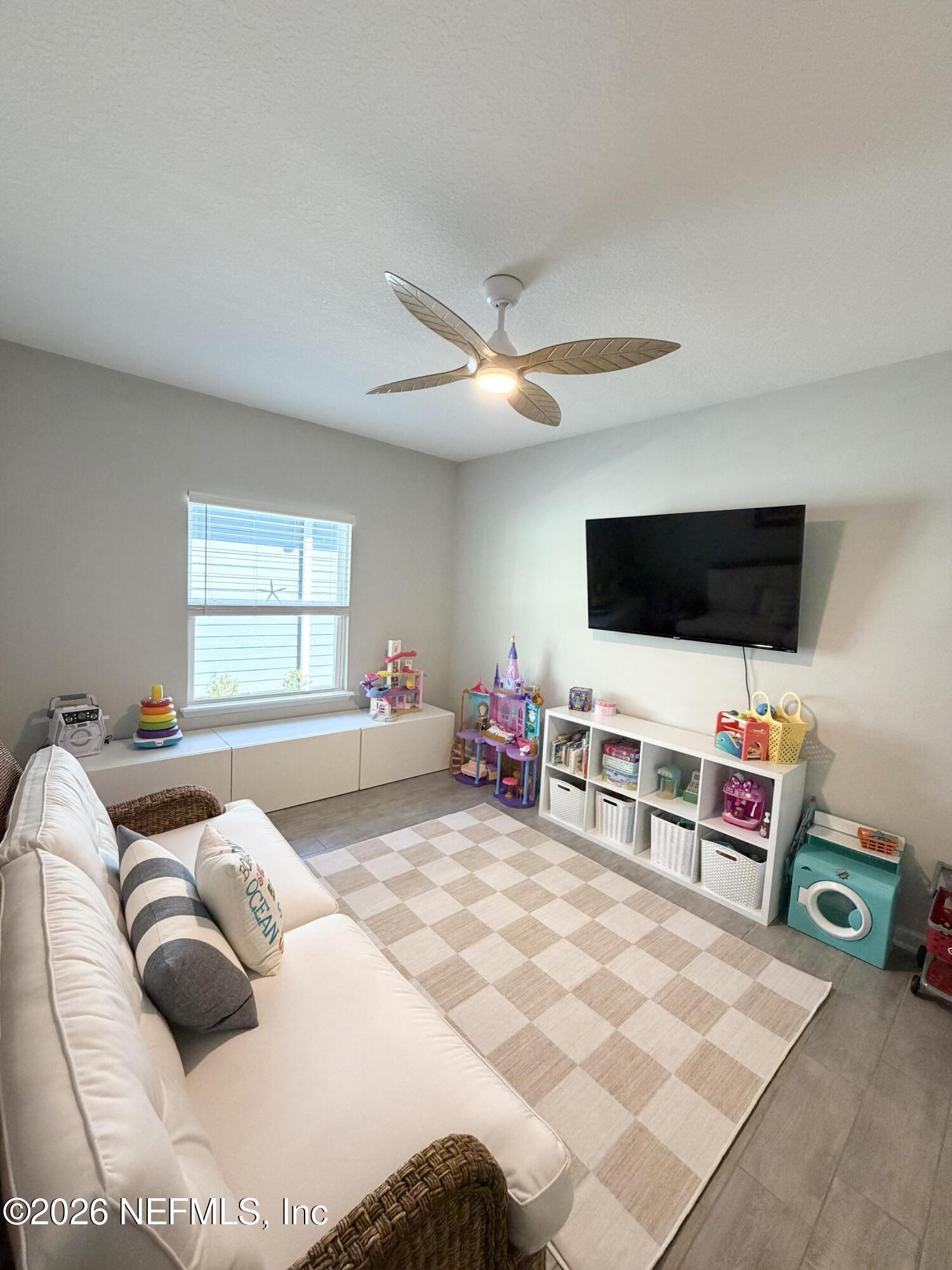 75457 Banyan Way Yulee, FL 32097 - Photo 18 of 36 a bedroom with furniture and a flat screen tv