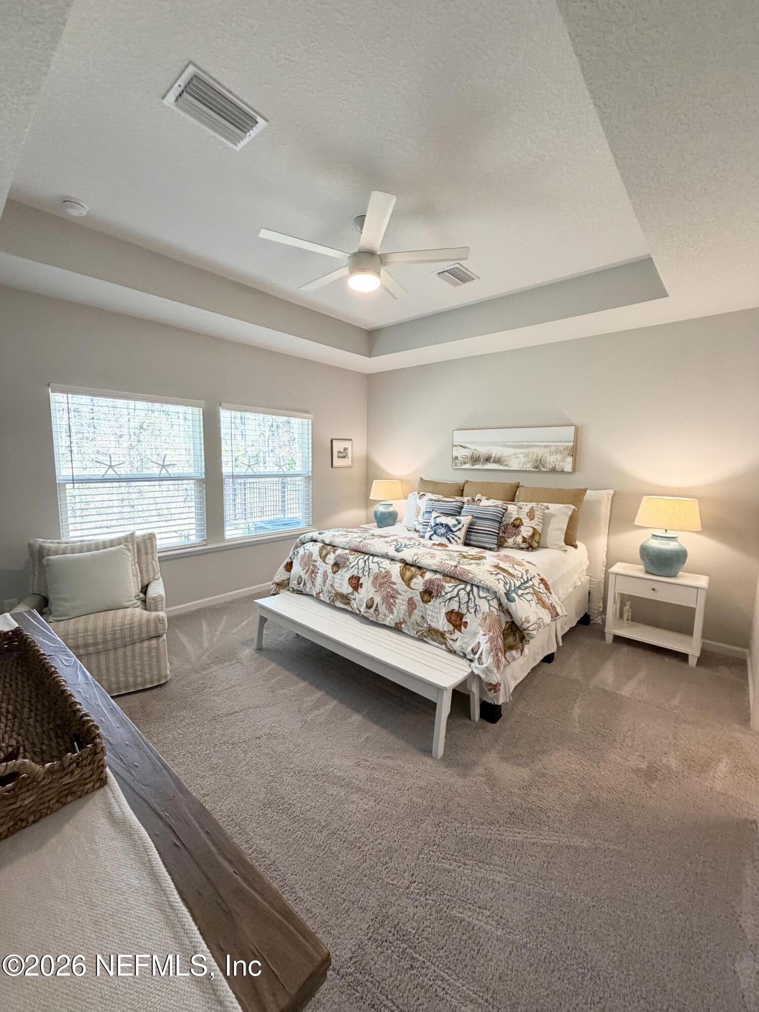 75457 Banyan Way Yulee, FL 32097 - Photo 24 of 36 a bedroom with bed couch and window