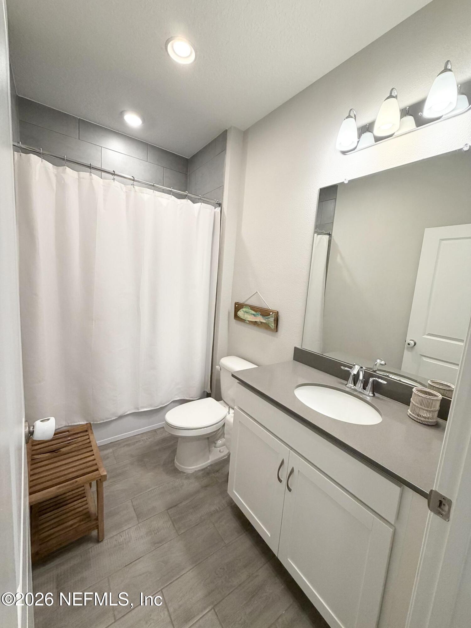 75457 Banyan Way Yulee, FL 32097 - Photo 8 of 36 a bathroom with a sink a toilet and mirror