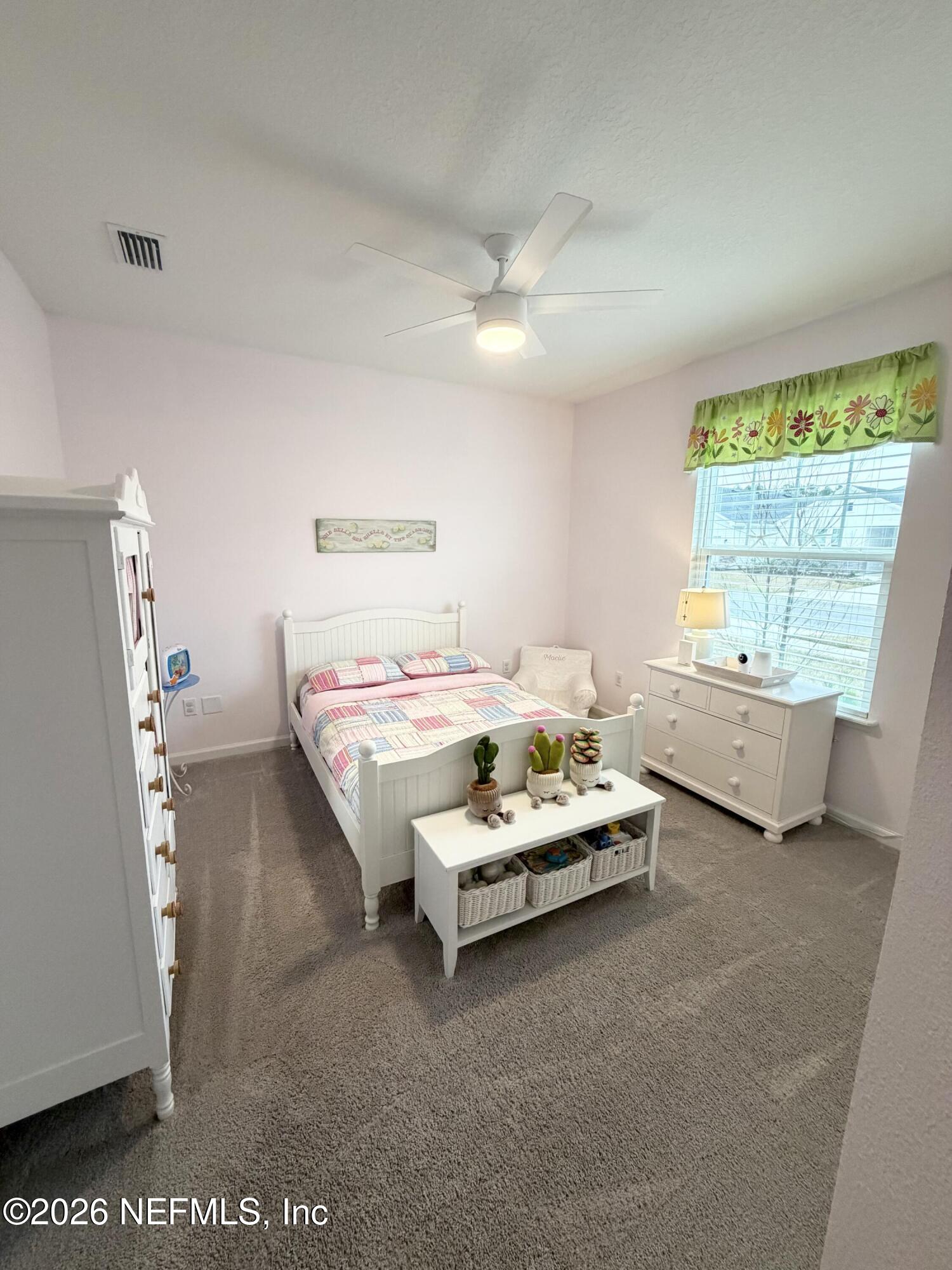 75457 Banyan Way Yulee, FL 32097 - Photo 9 of 36 a bedroom with bed and a large window
