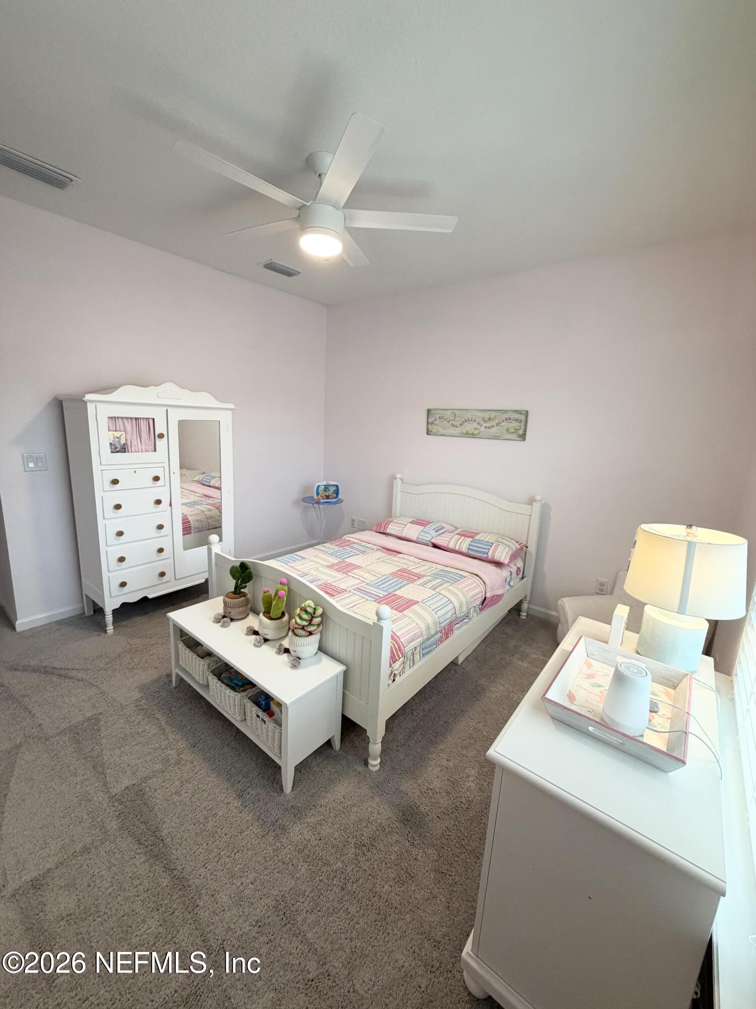 75457 Banyan Way Yulee, FL 32097 - Photo 10 of 36 a bedroom with a bed and a chandelier