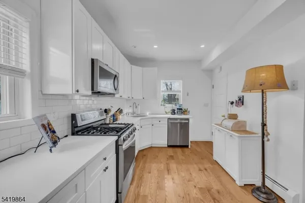 a kitchen with a sink stove and microwave