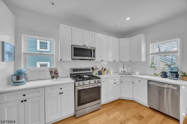 a kitchen with a sink stove oven and cabinets