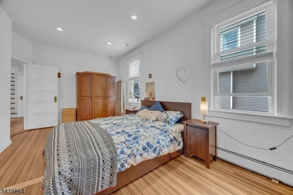 a bedroom with a large bed and a dresser