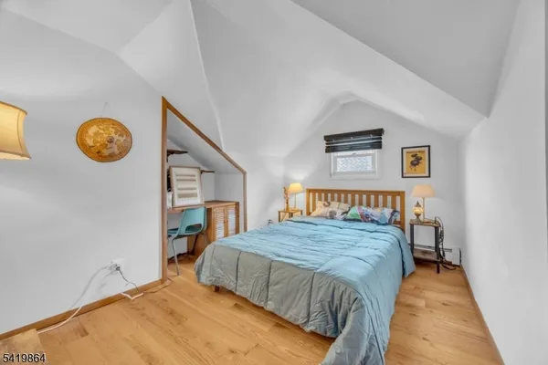 a bedroom with a bed and a wall painting