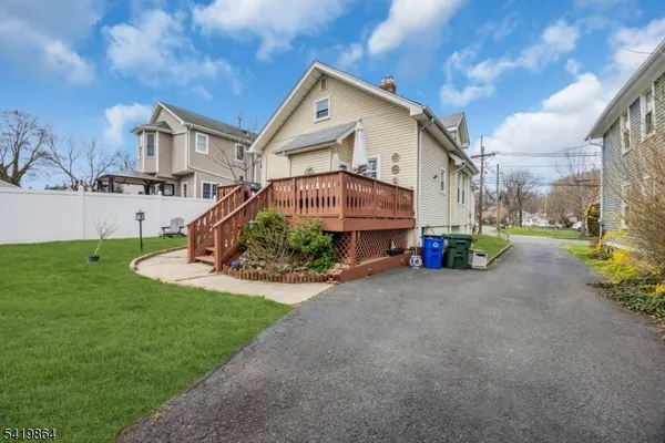 a view of a house with a yard and pathway