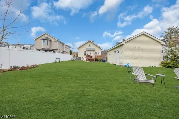 a front view of a house with a garden and yard