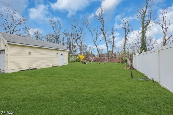 a view of an house with backyard space and garden