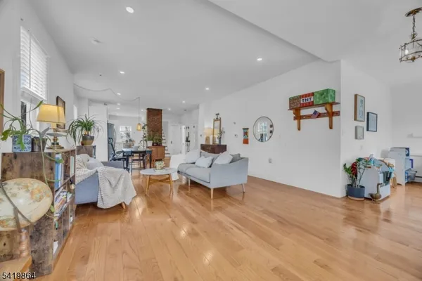 a living room with furniture and a chandelier