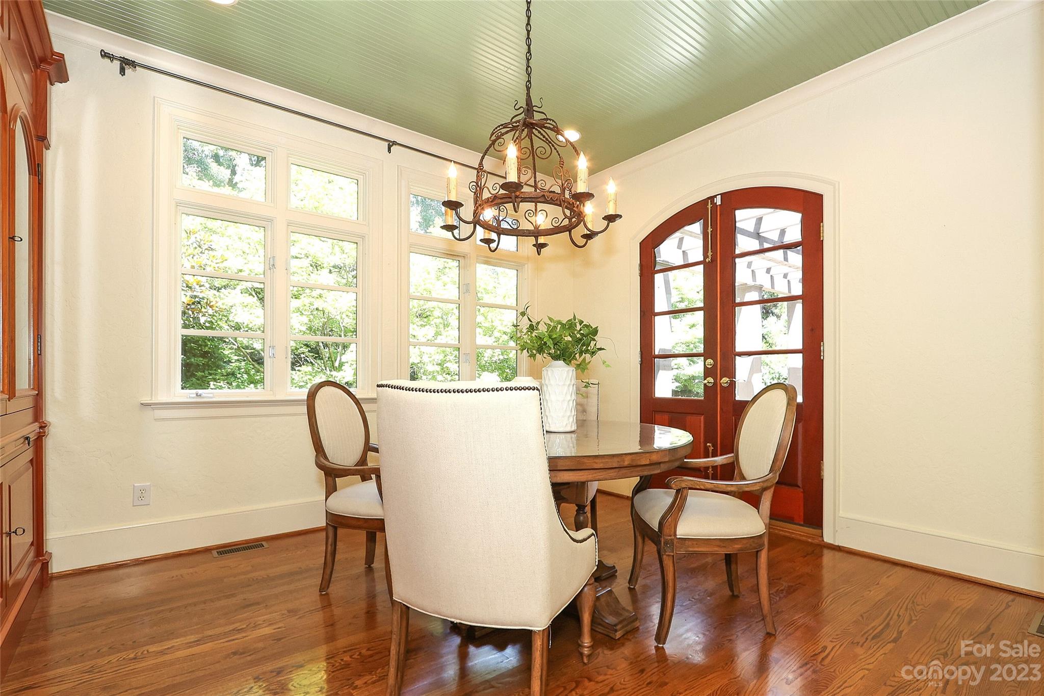 2416 Warburton Road Charlotte, NC 28211 - Photo 18 of 46 a dining room with furniture a chandelier and wooden floor