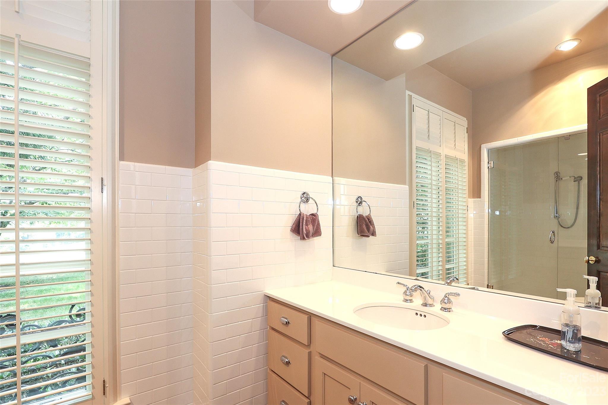 2416 Warburton Road Charlotte, NC 28211 - Photo 21 of 46 a bathroom with a double vanity sink and a mirror