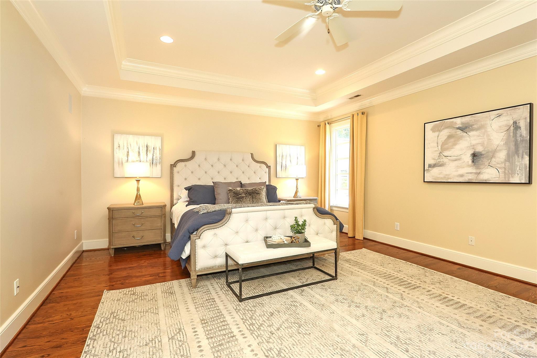 2416 Warburton Road Charlotte, NC 28211 - Photo 22 of 46 a spacious bedroom with a bed and a painting on the wall