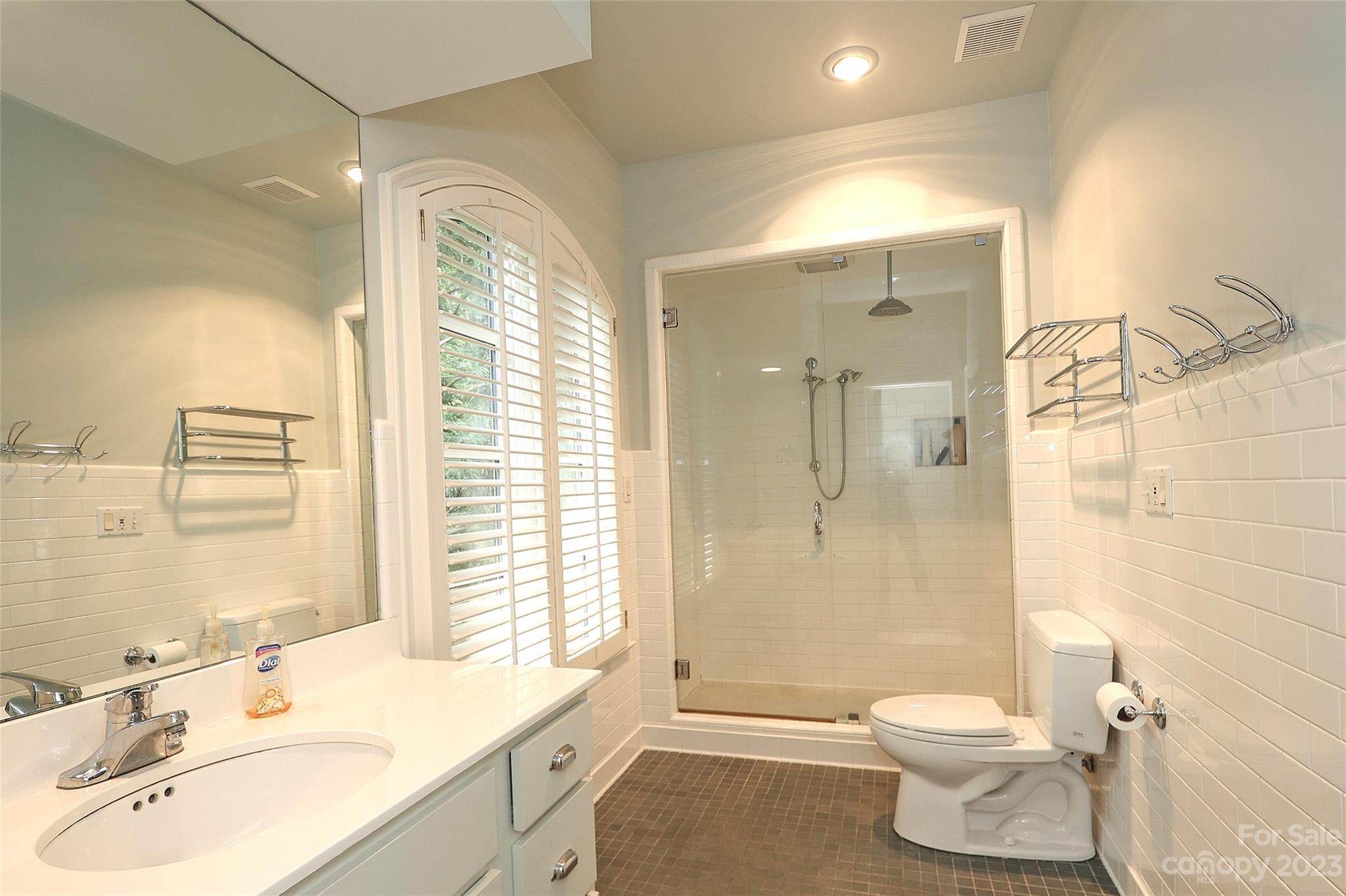 2416 Warburton Road Charlotte, NC 28211 - Photo 30 of 46 a bathroom with a sink toilet a shower and a mirror