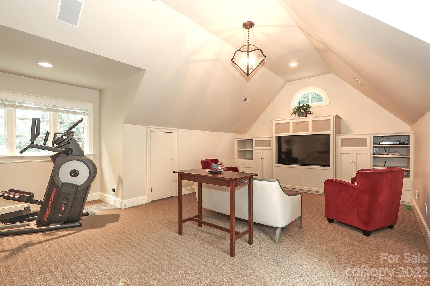 2416 Warburton Road Charlotte, NC 28211 - Photo 33 of 46 a living room with furniture a flat screen tv and kitchen view