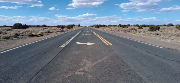 a view of a city street with ocean