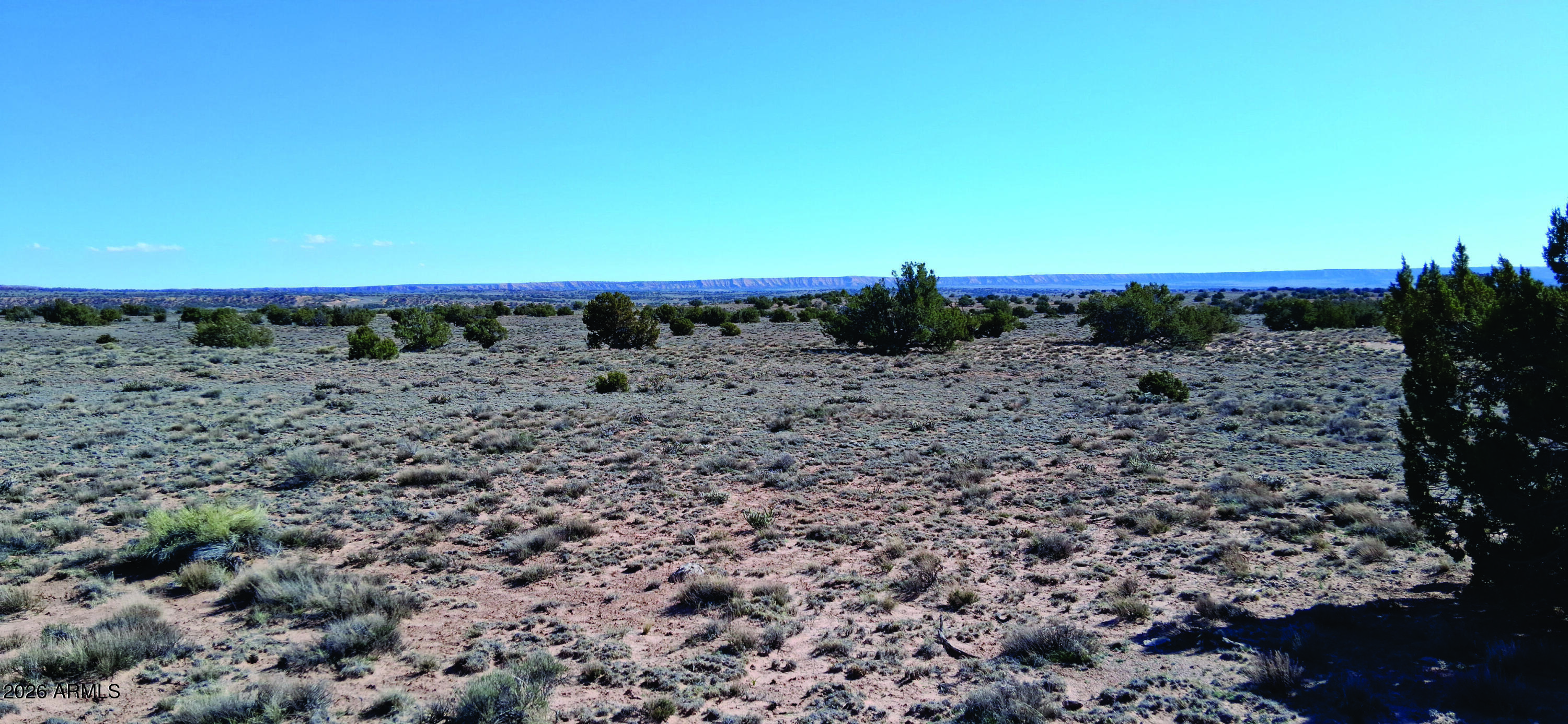 10.15-ac 10.15-ac Unnamed Road Sanders, AZ 86512 - Photo 6 of 23 a view of a beach with a building in the background