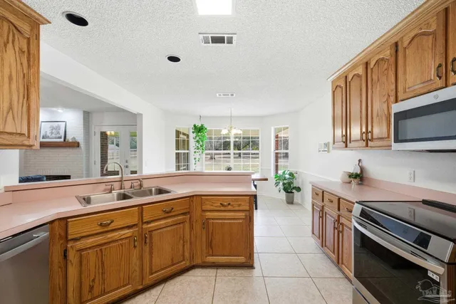 a kitchen with a sink stove and cabinets