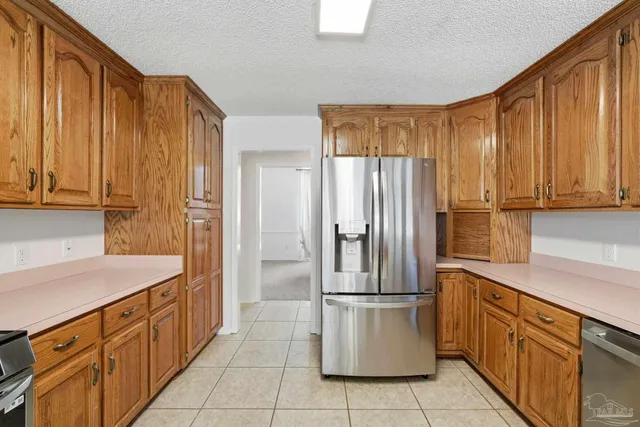 a kitchen with stainless steel appliances granite countertop a refrigerator and a sink