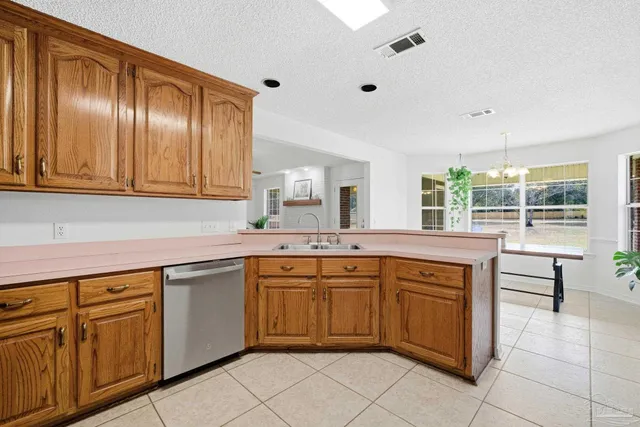a kitchen with stainless steel appliances granite countertop cabinets and window